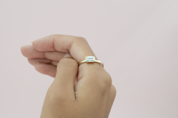 1 carat Emerald Cut Solitaire with an East-West setting using 14k Gold. 