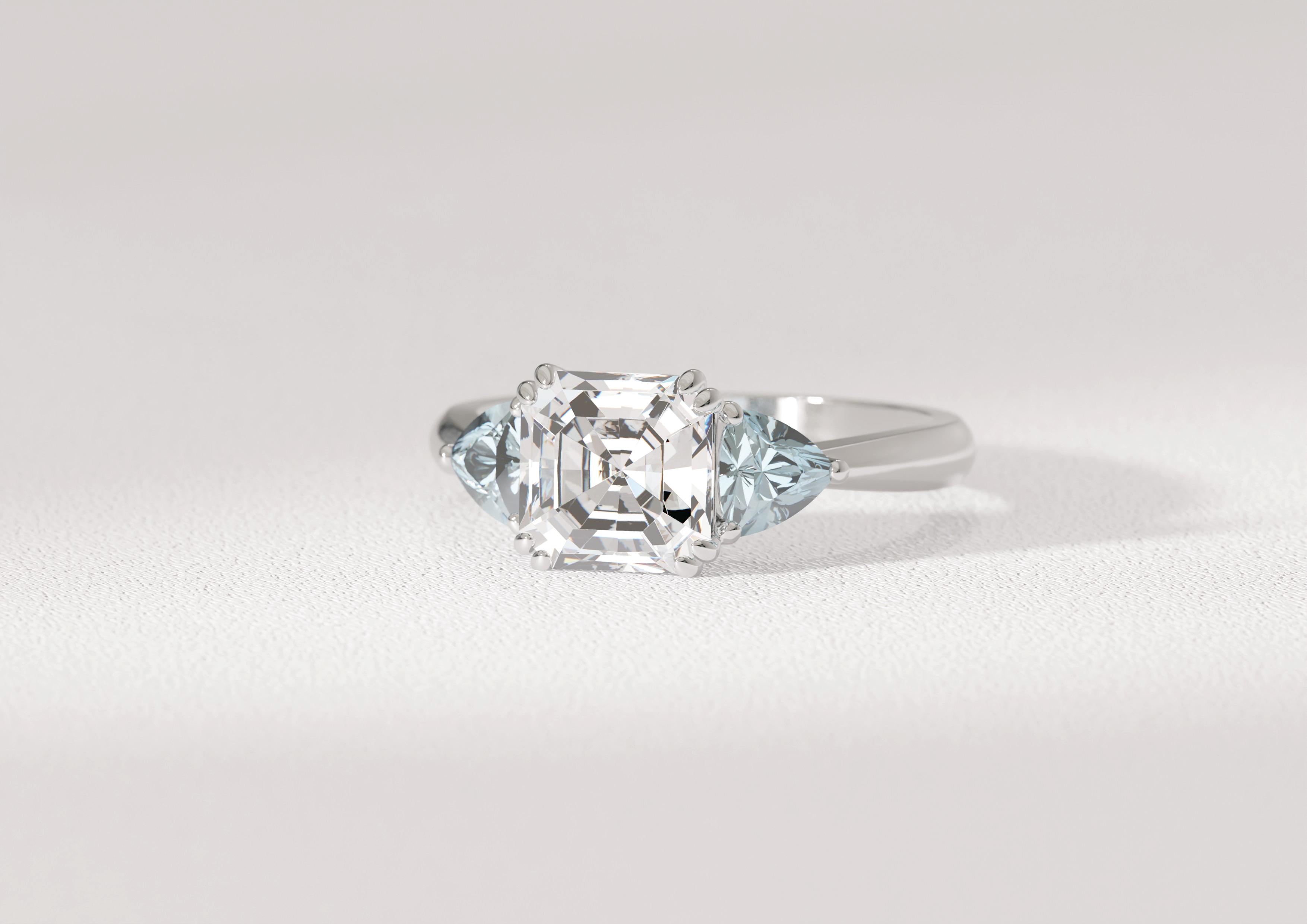 1.5 carat Asscher cut diamond centre stone with two accenting pear aquamarines
