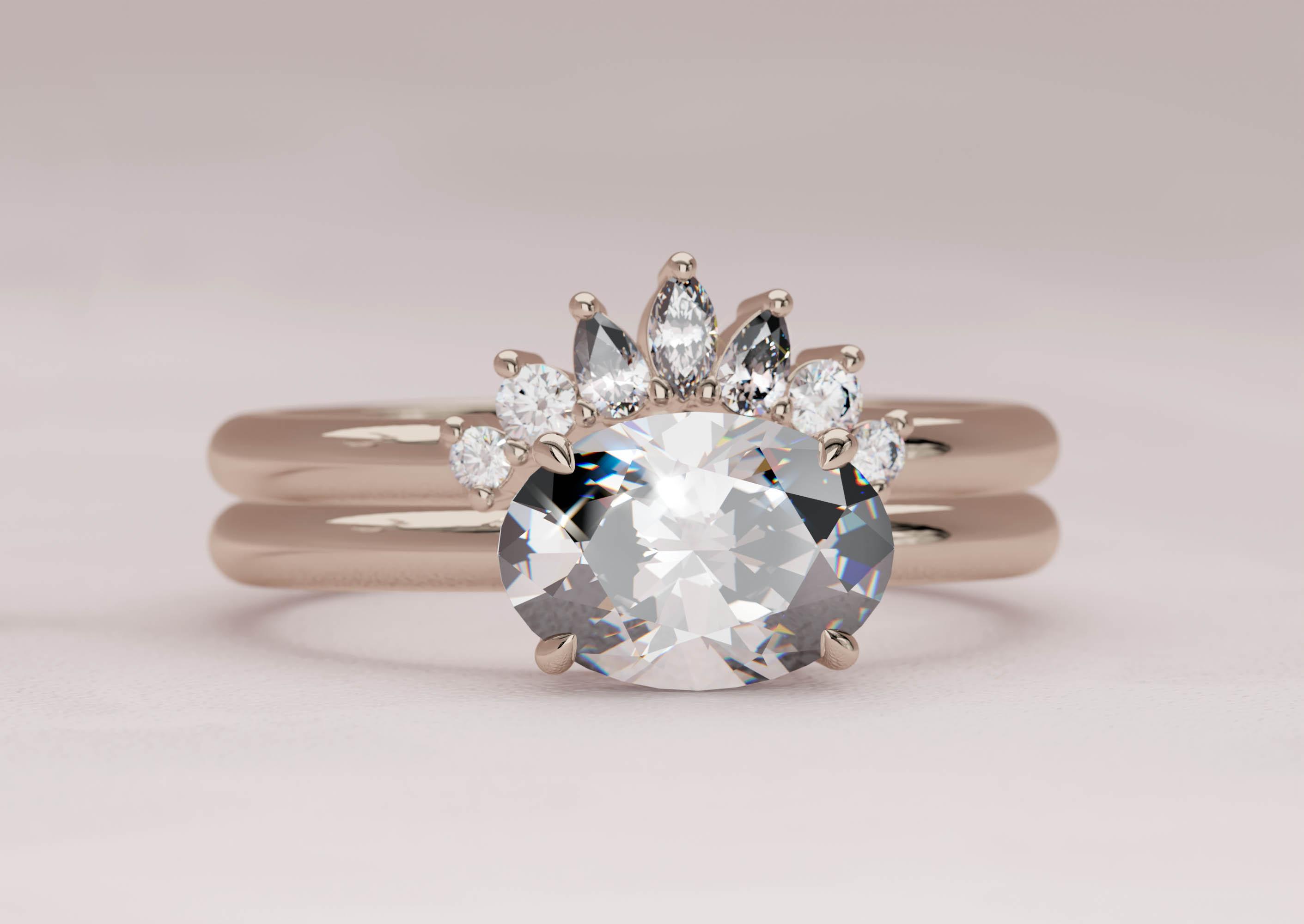 East-West Bridal Set featuring an 1.5 carat Oval Solitaire and a curved band featuring round and marquise diamonds