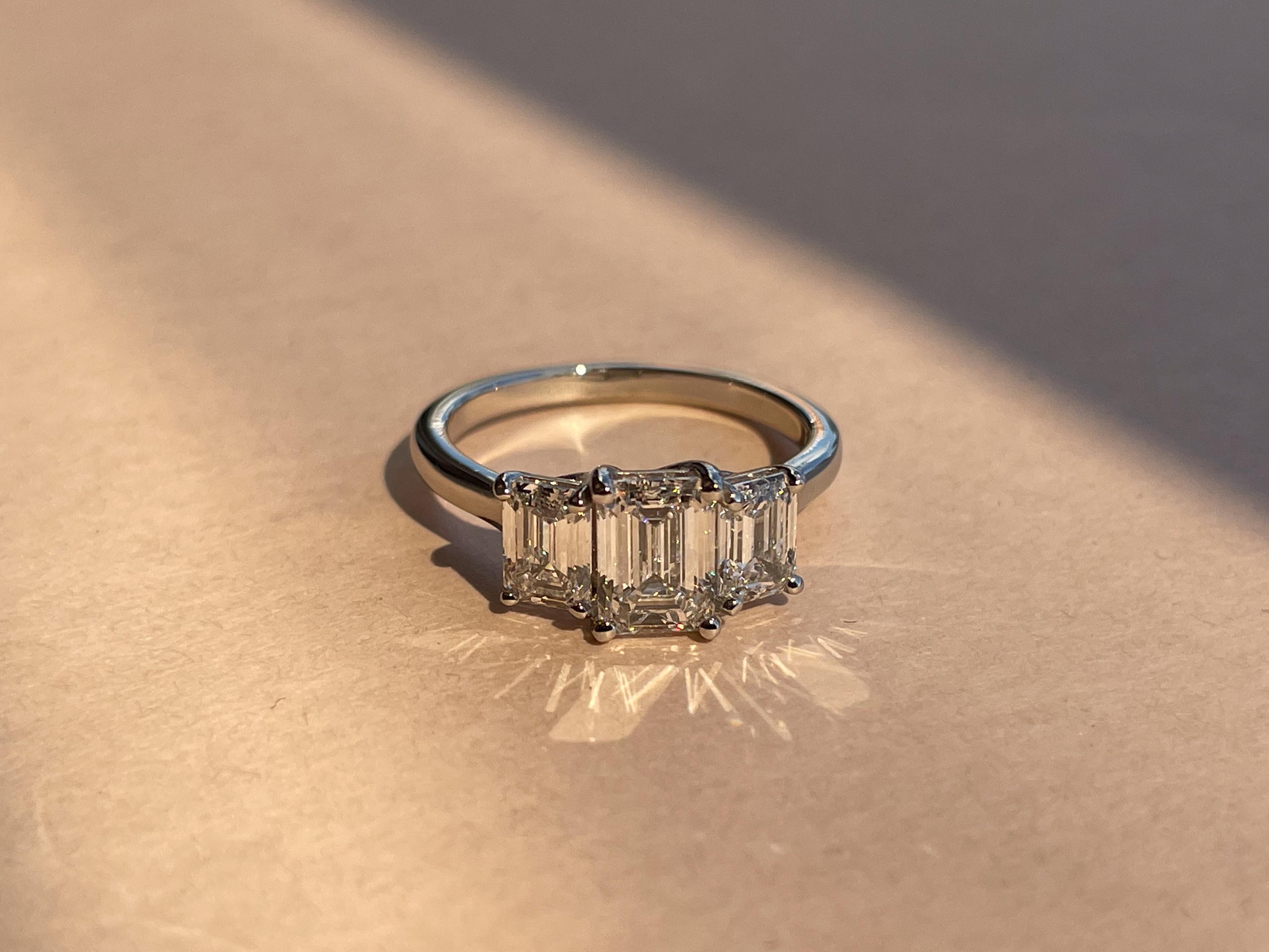 3 stone Emerald Cut diamond engagement ring with a platinum band