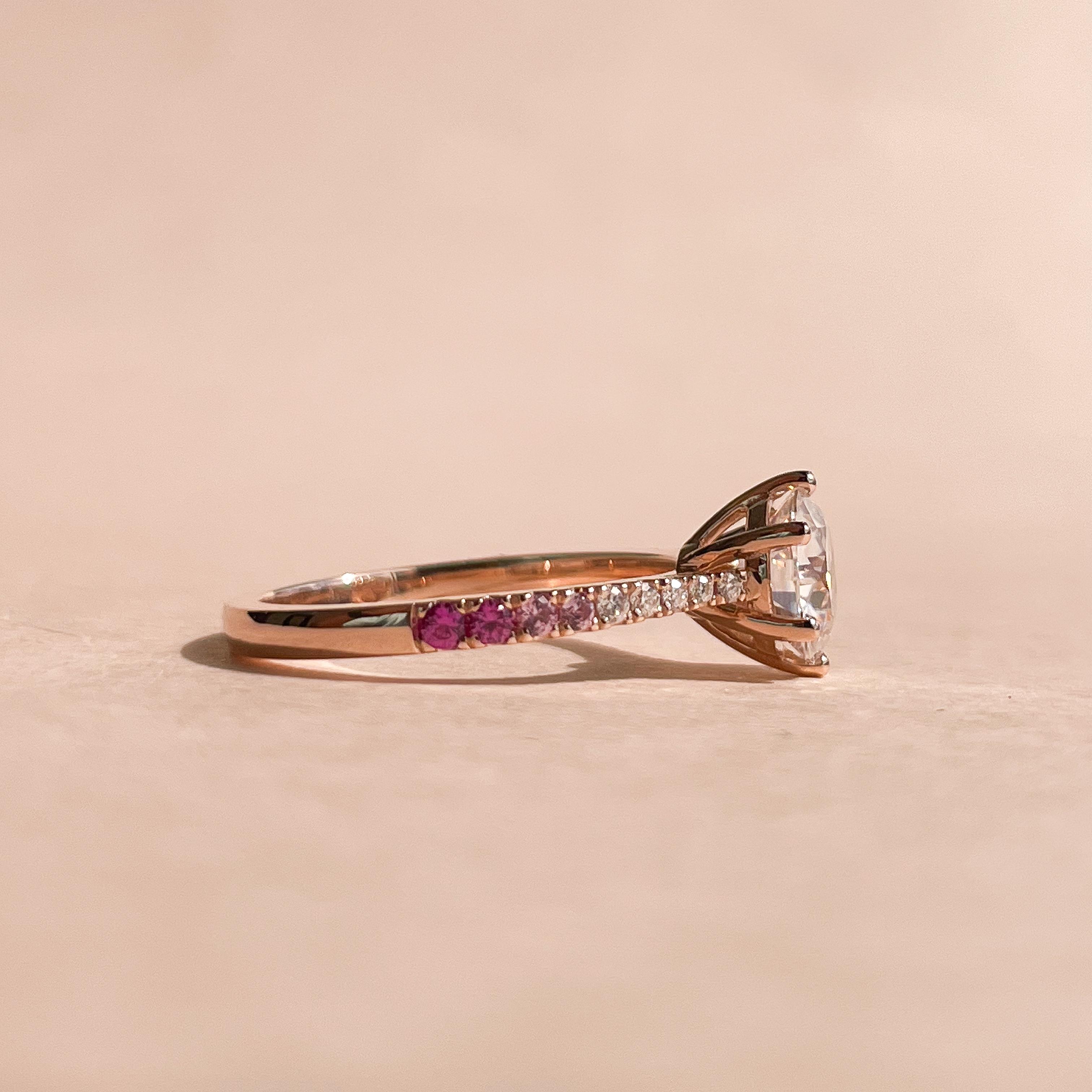 1 carat round diamond solitaire with pave diamonds in a rose gold band