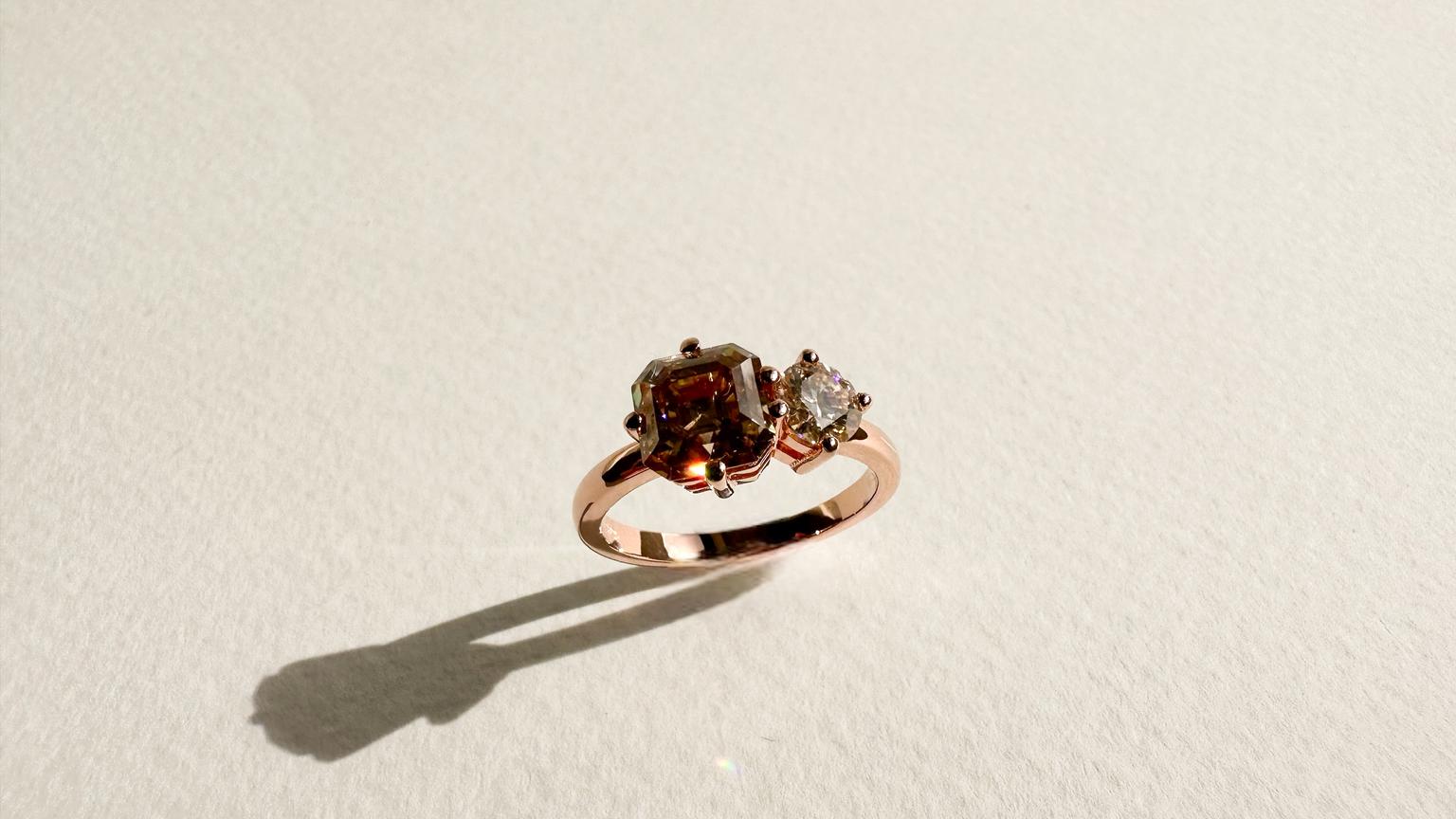 Toi et moi cognac coloured Asscher cut moissanite and champagne coloured round moissanite in a rose gold band.