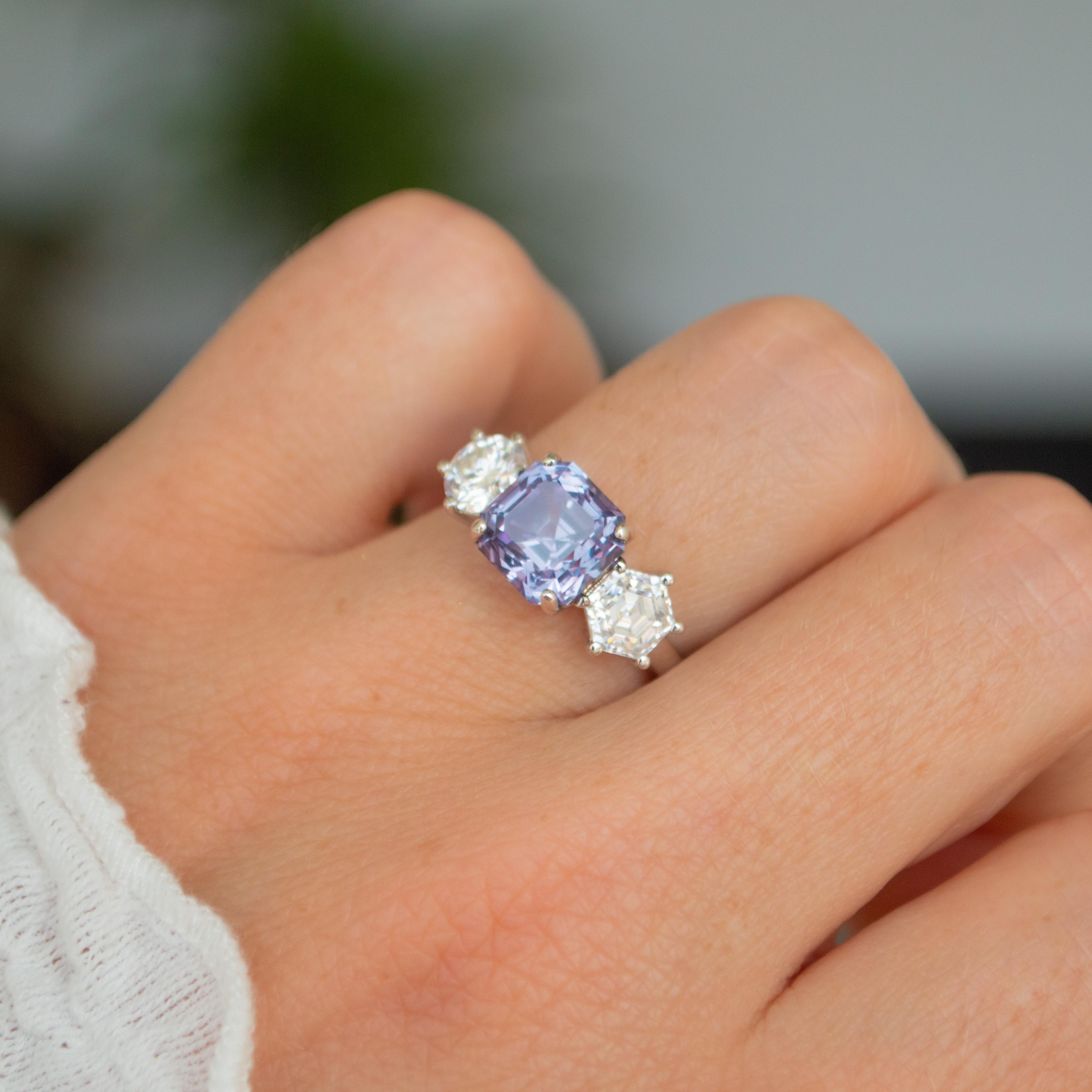 3 stone engagement ring with Asscher cut sapphire with hexagonal cut diamonds