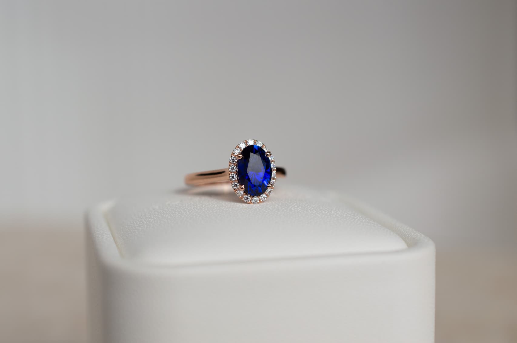 Oval sapphire engagement ring with halo in yellow gold band