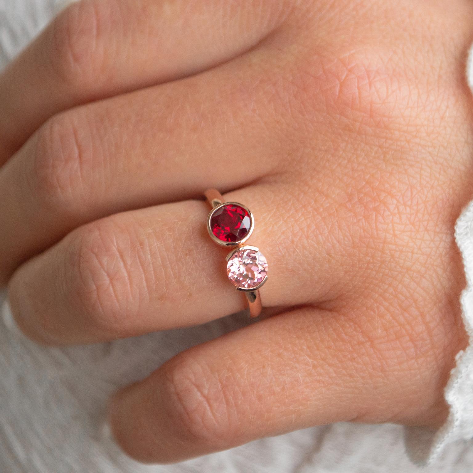 Toi et moi round cut ruby in full bezel and round cut pink sapphire in half bezel engagement ring in a yellow gold band.